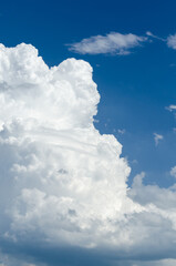 Fluffy white cumulus clouds in a blue sky on a beautiful day, natural soft background with copy space for text