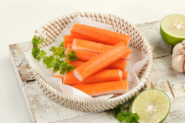 fresh crab sticks with lemon on white table © ROHE Creative Studio