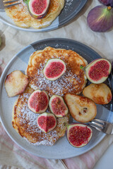 Fototapeta na wymiar Pancakes with syrup and figs on top