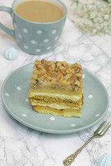 Piece of cake with coffee on a light backgroud 