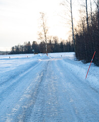 Snowy and icy road that is plowed and covered in grit