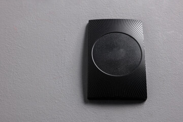 Magnetic door lock on grey textured wall, space for text. Home security