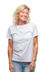 Fototapeta premium Middle age blonde woman over isolated background looking away to side with smile on face, natural expression. Laughing confident.