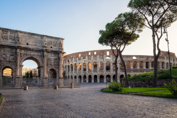 Amazing panoramic view of Arch of Constantine (Arco di Constantino) and Colosseum at beautiful warm...