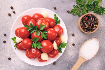 Image of red pizzcled canned tomatoes on a plate. Image of red canned tomatoes on a white plate