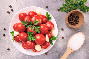 Image of red pizzcled canned tomatoes on a plate. Image of red canned tomatoes on a white plate