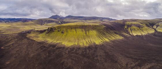 Aerial view over landscape with moss covered hills of volcanic ash and debris, Iceland