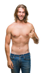 Fototapeta na wymiar Young handsome shirtless man with long hair showing sexy body over isolated background doing happy thumbs up gesture with hand. Approving expression looking at the camera with showing success.