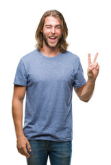 Young handsome man with long hair over isolated background smiling with happy face winking at the...