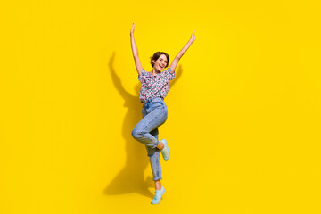 Fototapeta na wymiar Full length photo of carefree gorgeous person raise hands rejoice dancing empty space isolated on yellow color background