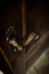 Curly antique door handle close-up. Major renovation of the old mansion
