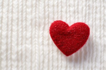 Red Knitted Heart on White Textured Background