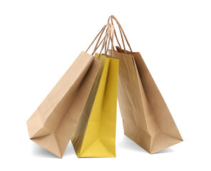 Kraft and yellow paper shopping bags isolated on white
