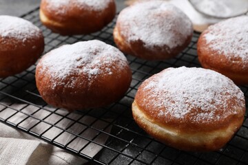 Delicious sweet buns with powdered sugar on table, closeup
