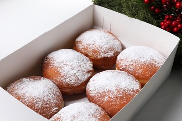 Delicious sweet buns in box on table, closeup