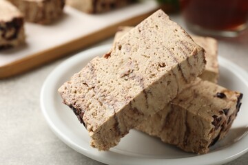 Tasty chocolate halva on grey table, closeup