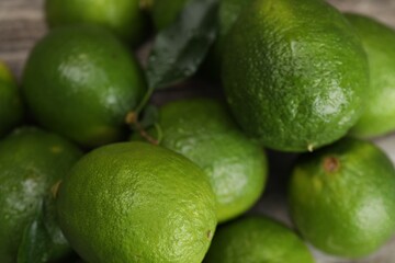 Pile of fresh limes on table, closeup