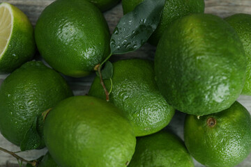 Pile of fresh wet limes on table, top view