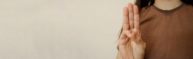 Girl showing three fingers with her hand. Day for the Abolition of Slavery. World Day Against the...