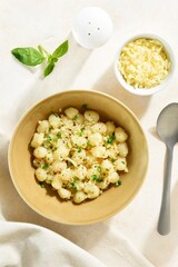 Potato gnocchi with parmesan cheese, greens and black pepper