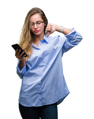Fototapeta premium Young beautiful blonde business woman using smartphone over isolated background with angry face, negative sign showing dislike with thumbs down, rejection concept