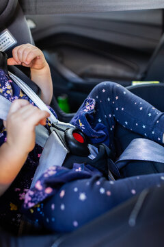 Buckle and straps done up with toddler in extended rear facing car seat