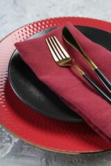 Clean plates, cutlery and napkin on table, closeup