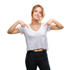 Young beautiful woman over isolated background looking confident with smile on face, pointing...