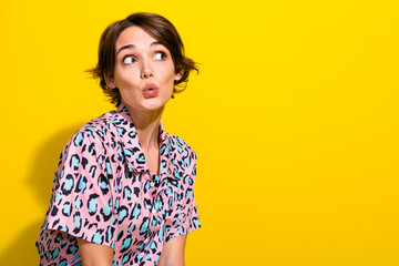 Profile portrait of speechless impressed person pouted lips look empty space ad isolated on yellow color background