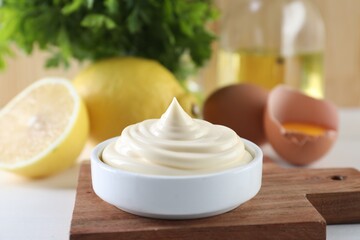 Fresh mayonnaise sauce in bowl on white table, closeup