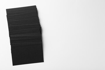 Blank black business cards on white background, top view. Mockup for design
