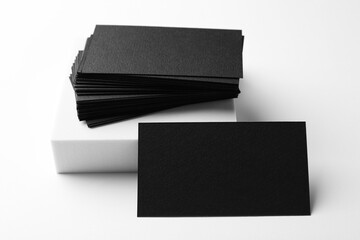 Blank black business cards on white background. Mockup for design