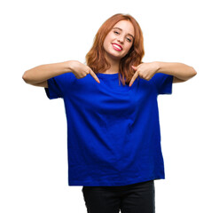 Young beautiful woman over isolated background looking confident with smile on face, pointing...