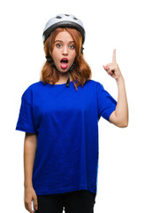 Young beautiful woman wearing cyclist helmet over isolated background pointing finger up with successful idea. Exited and happy. Number one.