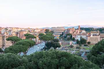 Fototapeta na wymiar Ancient Rome, Coliseum (Colosseo), Imperial Forums (Fori Imperiali) and aerial panoramic view of the ancient city. Via dei Fori Imperiali (Imperial Forums street)