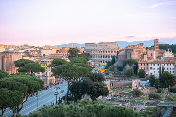 Fototapeta na wymiar Italy, Rome, Coliseum (Colosseo), Imperial Forums (Fori Imperiali) and aerial panoramic view of the ancient city. Via dei Fori Imperiali (Imperial Forums street)