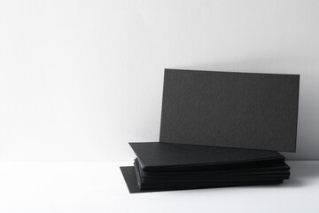 Blank black business cards on white background. Mockup for design