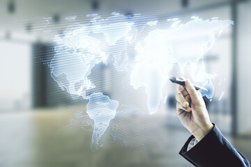 Multi exposure of businessman hand with pen working with abstract creative digital world map hologram on blurred office background, research and analytics concept