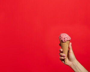 Hand Holding Strawberry Ice Cream Cone - 711431920