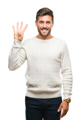 Naklejka premium Young handsome man wearing winter sweater over isolated background showing and pointing up with fingers number four while smiling confident and happy.