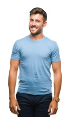 Fototapeta premium Young handsome man over isolated background looking away to side with smile on face, natural expression. Laughing confident.