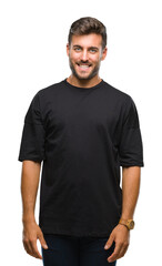 Young handsome man over isolated background looking away to side with smile on face, natural expression. Laughing confident.