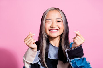 Photo of lovely cheerful person beaming smile arms fingers demonstrate korean heart love symbol isolated on pink color background