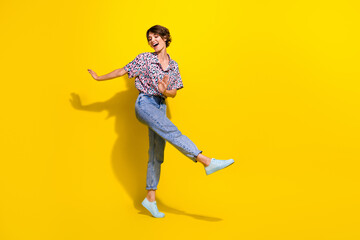 Fototapeta na wymiar Full length portrait of positive pretty person have good mood dancing empty space isolated on yellow color background