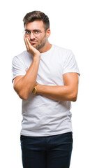 Young handsome man wearing glasses over isolated background thinking looking tired and bored with depression problems with crossed arms.