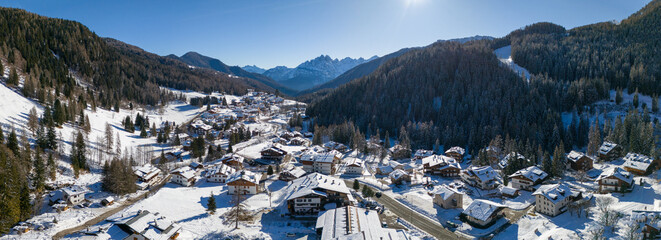 Aerial view of snowy Val di Zoldo, Italy with charming houses and beautiful nature