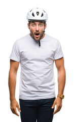Young handsome man wearing cyclist safety helmet over isolated background afraid and shocked with surprise expression, fear and excited face.