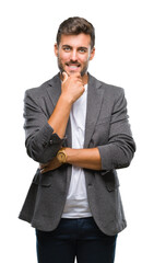 Young handsome business man over isolated background looking confident at the camera with smile with crossed arms and hand raised on chin. Thinking positive.