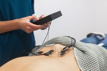 Medical Professional Attaching ECG Electrodes to Patient