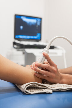 Ultrasound examination on patient's arm in clinic